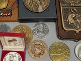 a lot of coins and medals on the table
