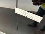 a man standing next to a car with a sign on it