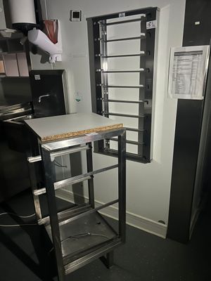 an image of a kitchen with a metal rack and a microwave