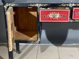 a red and black table with two drawers on it
