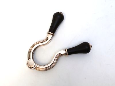 a close up of a pair of black handles on a white surface