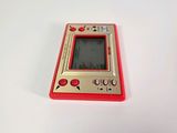 a red and gold gameboy sitting on a white surface