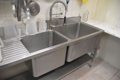 two sinks in a kitchen with a sink and a faucet