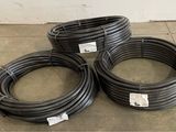 three black hoses sitting on top of a floor next to each other