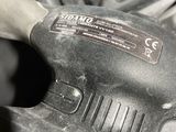 a black and white photo of a cordless tool