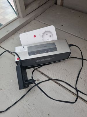 a remote control sitting on top of a table next to a window