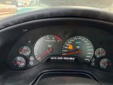 a close up of a car dashboard with a speedometer and gauges