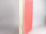 a pink book sitting on top of a white table