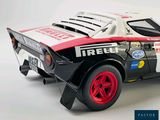 a model of a race car on display on a white surface
