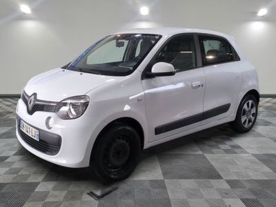 a picture of a small white car parked on a checkered floor