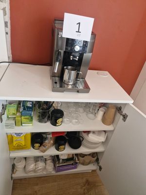 a coffee maker sitting on top of a shelf in the corner of a kitchen