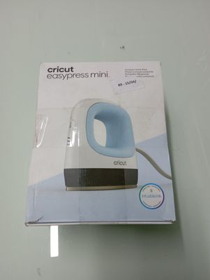 packaging of a white and blue electric hand blender on a glass table