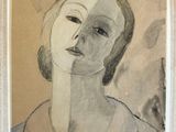 tableau représentant le visage d'une femme, dans un cadre blanc accroché au mur