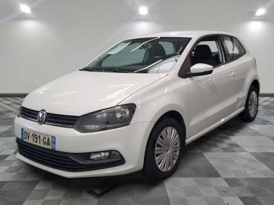 the white volkswagen polo is parked in a room with a checkered floor