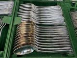 many spoons and forks in a green case