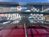 a close up of a roof rack on a red car