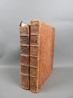 two old books sitting side by side on a table