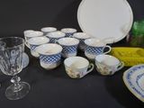 many cups and saucers sitting on a table
