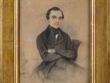 an old picture of a man in a suit sitting in front of a wall