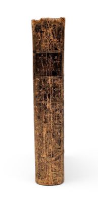 a tall wooden vase with a carved design on it
