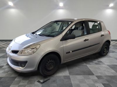a picture of a small silver car parked in a garage