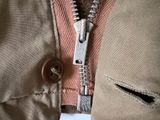 a close up of a zipper with a button on it