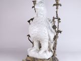 an image of a statue of a rooster on a tree branch
