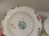 a person holding a cup and saucer in their hand