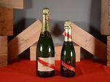 two bottles of wine sitting next to each other on a table