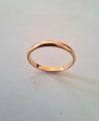 a close up of a gold ring on a white surface