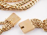 two gold chains and a usb drive attached to a gold chain