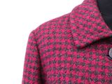 the jacket is red and black with a checkered pattern on it