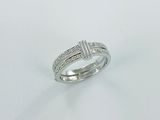 a close up of a diamond ring on a white surface