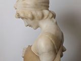 marble statue of a woman holding a baby in her arms