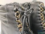 laces on the side of a pair of black leather boots