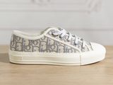 the white and grey sneakers are on a wooden table