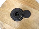 a camera lens sitting on top of a wooden table