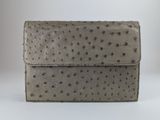 un portefeuille en cuir d'autruche gris avec une fermeture à rabat