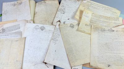a pile of old papers sitting on top of a table