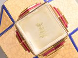 a gold plate with a blue border around it
