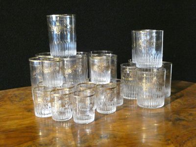 a lot of glasses sitting on a table with a black background