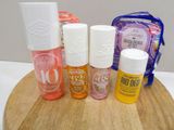 five different bottles of nail polish on a wooden board