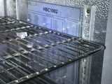 a silver oven with a glass door that has a label on it