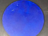 a blue disc sitting on a black counter top