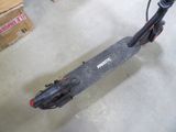 a scooter that is sitting on the floor in a room
