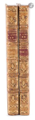 two old books sitting on top of each other on a white surface