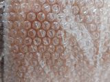 a teddy bear that is wrapped in bubble wrap