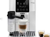 a white coffee machine sitting next to two cups of coffee