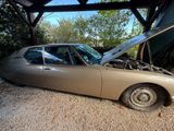 a car that is parked in a garage with its hood open