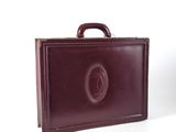a brown briefcase that is sitting on a white surface